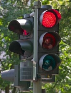 close up of stop light showing red light Queener Law