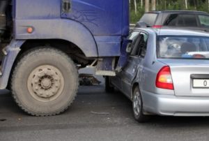 semi truck hits a compact car Queener Law