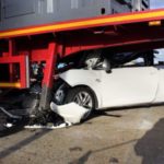 sports car crashes under semi truck bed Queener Law