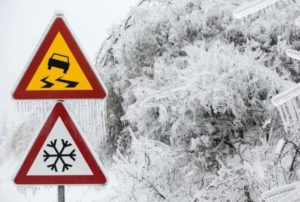 slippery snowy warning signs on road Queener Law