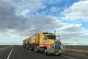 large yellow semi truck on highway Queener Law