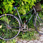 broken bike with old chain and bent tires Queener Law