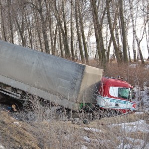 semi truck rolled down hill near overpass Queener Law