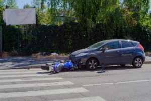 view from street of car vs motorcycle accident Queener Law
