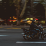 man riding motorcycle lane splitting Queener Law