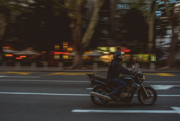 man riding motorcycle lane splitting Queener Law