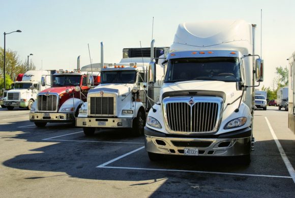 semi trucks lined up in parking lot Queener Law