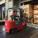 forklift driver getting boxes in warehouse Queener Law
