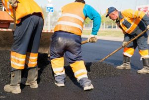 construction workers laying asphalt in work zone is dangerous Queener Law