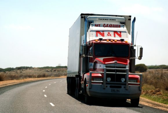 semi truck driving on highway Queener Law
