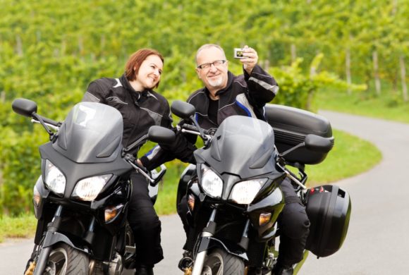man and woman stop to take selfie on motorcycles Queener Law