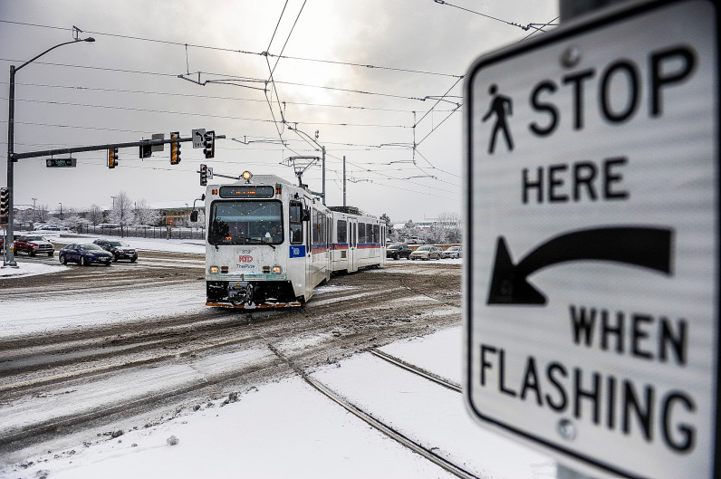 Image of a snowy day in which an RTD train is proceeding properly at the same intersection as the derailment.